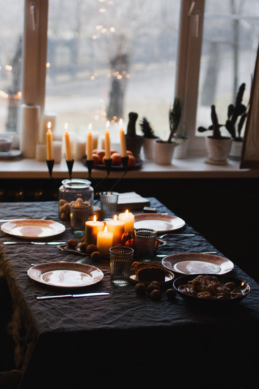A candle-lit table set for four.