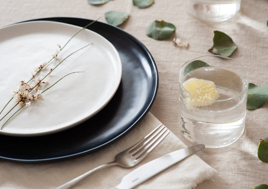 A set table decorated with dried flower petals.