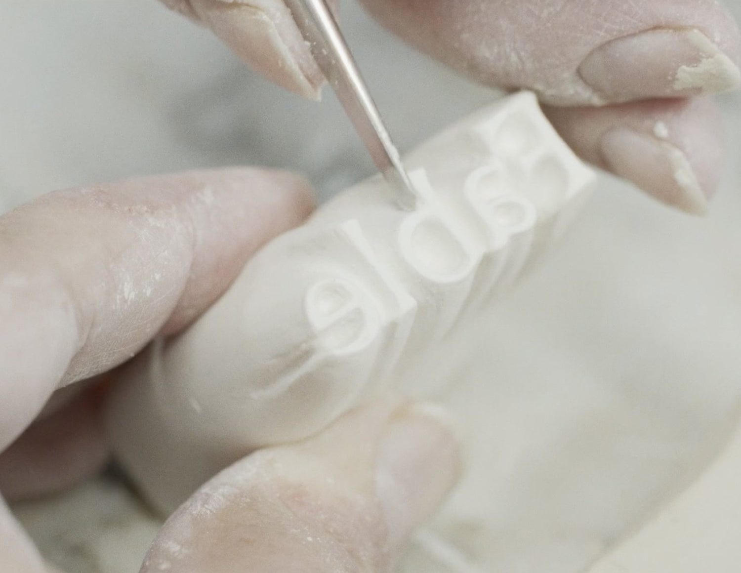 A close-up look at a Fable stamp being carved by hand.