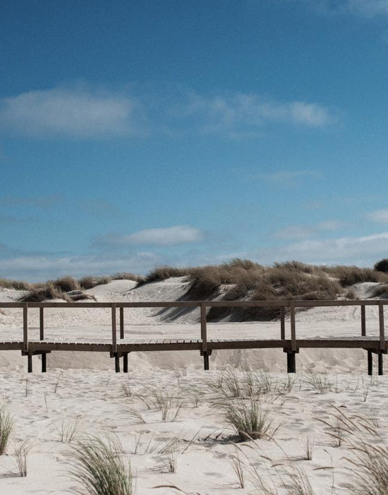 A white sandy landscape with a blue sky